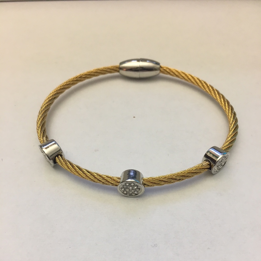 Raised crystals on cable magnetic bracelet.